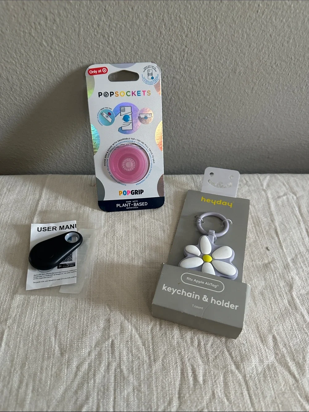 Pink PopSockets for phone, keychain & holder for air tags, a black tracking fob